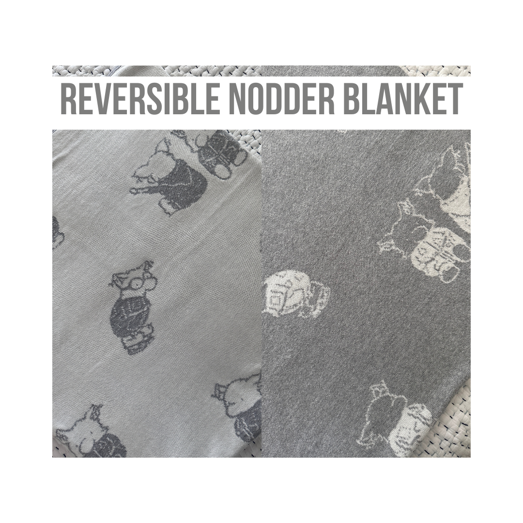 The Nodder Blanket is reversible with gray background and white characters on one side and  a white background and gray characters on the other side.